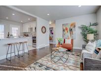 Bright living room with hardwood floors, stylish furniture, and an open concept kitchen at 3430 N Cook St, Denver, CO 80205