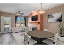 Cozy living room featuring a fireplace, comfortable seating, and natural light from a large window at 9039 E Panorama Cir # C204, Englewood, CO 80112