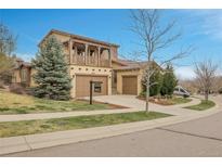 Charming home with a covered balcony, well-maintained lawn, and a three-car garage at 2344 S Lupine St, Denver, CO 80228