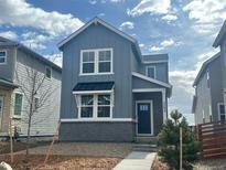 Charming two-story home featuring a modern exterior with stylish accents and a well-maintained front yard at 3292 N Catawba Way, Aurora, CO 80019