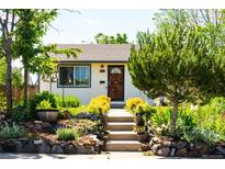 Charming home featuring a cozy entrance with well-kept landscaping and inviting front steps at 1735 S Wyandot St, Denver, CO 80223