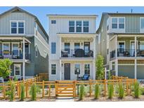 Charming two-story home with a fenced front yard and balcony, perfect for enjoying the outdoors at 14952 Gladshine Dr, Parker, CO 80134