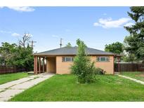 Charming single story home with a carport and a well-maintained lawn at 10505 Lowry Pl, Aurora, CO 80010