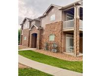 Charming exterior featuring stone accents, private balconies, and well-maintained landscaping at 7440 S Blackhawk St # 9-108, Englewood, CO 80112
