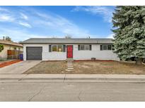 Charming single-story home featuring a red door, gray garage, and brick exterior at 5124 Wheeling St, Denver, CO 80239