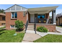 Charming brick home with a cozy front porch and well-maintained landscaping at 2430 S Ogden St, Denver, CO 80210