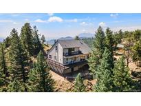 Stunning mountain home with wrap-around deck and picturesque views from a wooded lot at 251 Ridgeview Ln, Boulder, CO 80302