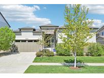 Charming single-story home with a well-manicured lawn and attached two-car garage at 27423 E Euclid Dr, Aurora, CO 80016