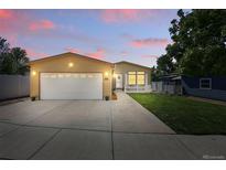 Charming single-story home featuring a well-maintained lawn, a two-car garage, and inviting curb appeal at 6231 Indian Paintbrush St # 214, Frederick, CO 80530