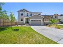 Charming two-story home with a well-manicured lawn and a two-car garage at 5078 S Quail St, Littleton, CO 80127