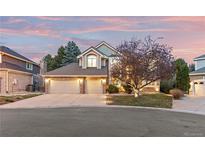 Charming two-story home with a well-manicured lawn and a spacious three-car garage at 6132 S Boston Cir, Englewood, CO 80111