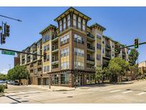 Modern multi-story building with brick and siding, showcasing a contemporary urban living space with many windows and street access at 1441 Central # 305, Denver, CO 80211