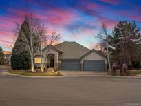 Charming home with a three-car garage, complemented by a serene yard and mature trees at 1391 S Uinta Ct, Denver, CO 80231
