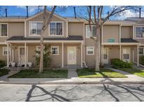 Charming townhouse showcasing a well-maintained front yard and covered entrance at 1818 S Quebec Way # 3-4, Denver, CO 80231