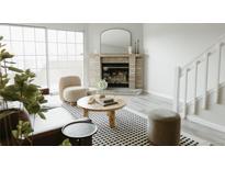 Bright living room with fireplace and modern furniture at 1818 S Quebec Way # 3-4, Denver, CO 80231