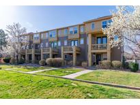 Townhome exterior boasting two-story layout with a well-manicured lawn and a cozy balcony on the second floor at 658 Casper Dr, Lafayette, CO 80026