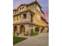 Beautiful exterior of a multi-story home with stone accents and a well-manicured lawn at 3437 Rosato Dr # C, Highlands Ranch, CO 80126