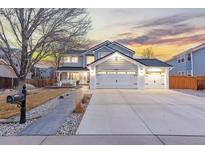 Charming two-story home with a three car garage and a well-manicured front yard at 18233 E Dorado Ave, Centennial, CO 80015