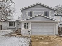 Charming two-story home with light blue siding, a two-car garage, and well-maintained front yard at 3833 S Bahama St, Aurora, CO 80013