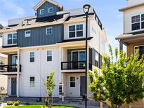 Charming three-story home with a balcony, modern design, and well-maintained landscaping at 6162 W 28Th Ct, Edgewater, CO 80214
