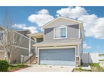Charming two-story home with a two-car garage and staircase leading to the front door at 5571 Killarney St, Denver, CO 80249