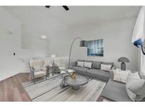 Bright living room with plush seating, modern decor, and stylish furnishings on hardwood floors at 5571 Killarney St, Denver, CO 80249