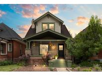 Charming two-story home featuring beautiful front porch and well-maintained landscaping at 3055 N York St, Denver, CO 80205