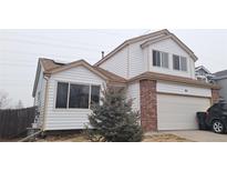 Two-story house with brick and vinyl siding, attached garage, and landscaping at 84 S Carlton St, Castle Rock, CO 80104