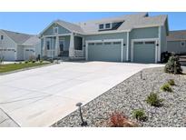 Charming two-story home boasts a spacious driveway and a two-car garage, perfect for modern living at 1030 W Hopkins Dr, Elizabeth, CO 80107