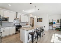 Bright, modern kitchen with stainless steel appliances, a granite island, and stylish pendant lighting at 1030 W Hopkins Dr, Elizabeth, CO 80107