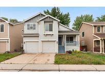 Charming two-story home featuring a well-maintained front yard and a convenient two-car garage at 1241 S Akron Way, Denver, CO 80247