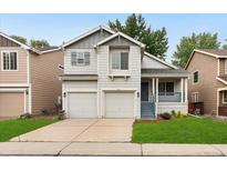 Charming two-story home with a two-car garage, covered porch, and well-maintained lawn at 1241 S Akron Way, Denver, CO 80247
