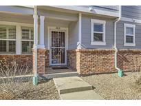 Inviting house entrance with brick accents and a security door at 5833 N Biscay St, Denver, CO 80249