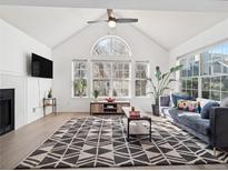 Bright living room with vaulted ceilings, large windows, and a modern patterned rug at 6755 S Ivy St # A7, Centennial, CO 80112