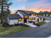 Stunning two-story home with lush landscaping and a paved walkway leading to the front entrance, ideal for Gathering living at 347 S White Tail Dr, Franktown, CO 80116