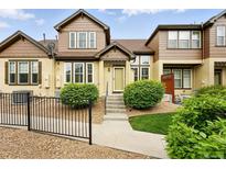 Charming townhouse featuring a landscaped front yard, steps to the front door, and decorative touches at 5836 S Vivian Way, Littleton, CO 80127
