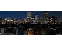 Night view showcases the beautifully lit Denver skyline from this listing at 800 N Washington St # 710, Denver, CO 80203