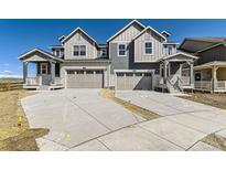 New construction two-story home featuring attached garages, classic curb appeal, and concrete driveways at 6719 Juniper Dr, Thornton, CO 80602