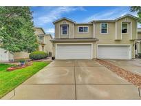 Two-story townhome with attached two-car garage and concrete driveway at 7946 S Kittredge St, Englewood, CO 80112