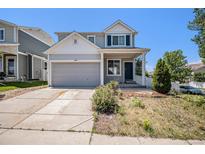 Charming two-story home with a well-manicured lawn and inviting front porch and attached two car garage at 20108 Randolph Pl, Denver, CO 80249