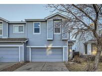 Two-story home featuring an attached two-car garage and light blue siding at 11039 Columbine St, Northglenn, CO 80233