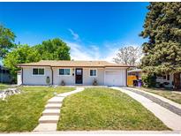Charming one-story home featuring a well-manicured lawn and inviting walkway to the front door at 1183 S Umatilla St, Denver, CO 80223
