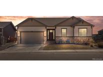 Inviting single-story home boasting beautiful stonework, a well-manicured lawn, and a charming front porch seating area at 6420 Agave Ave, Castle Rock, CO 80108