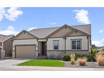 Charming home featuring stone accents, a well-manicured lawn, and a cozy seating area on the front porch at 6420 Agave Ave, Castle Rock, CO 80108