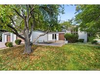 Charming single story home featuring mature trees and a well maintained front yard at 4941 Nassau W Cir, Cherry Hills Village, CO 80113