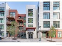 Striking multi-story apartment building with balconies and modern architectural details at 3100 Huron St # 3P, Denver, CO 80202