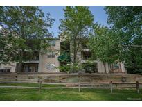 Inviting condo building with mature trees and meticulously maintained landscaping at 12208 W Dorado Pl # 207, Littleton, CO 80127