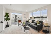 Charming living room featuring a comfortable sofa, balcony access, and scenic views at 1236 N Tennyson St, Denver, CO 80204