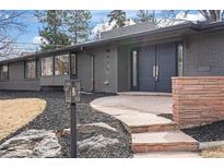 Stylish gray brick home featuring a modern double door entry, and landscaped front yard at 456 Cherry St, Denver, CO 80220