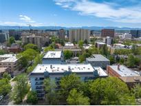 Scenic aerial view of the city buildings with mountain views, a perfect urban oasis at 555 E 10Th Ave # 111, Denver, CO 80203